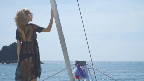 The blonde stands on the bow of the ship and looks at the sea. Stock Footage 83979455
