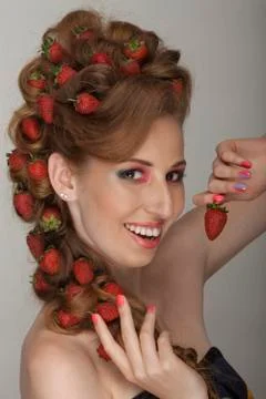 Blonde with strawberries in her hair and a Hollywood smile Stock Photos