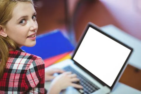 Blonde student using laptop during class 스톡 사진