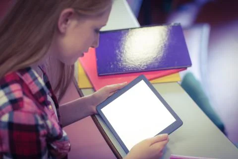 Blonde student using tablet during class 写真素材