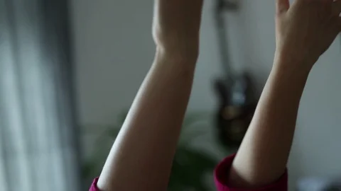 Blonde at the table in front of the window throws her hands behind his head Stock Footage 129709405