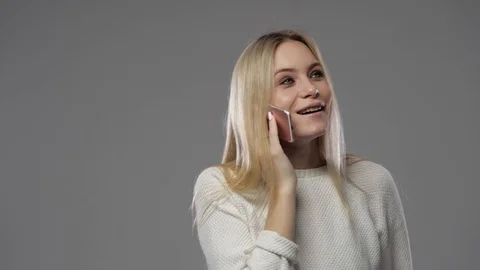 Blonde talking on the phone Video stock 104398311