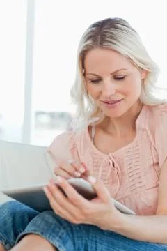 Blonde tapping on a touchpad Stock Photos