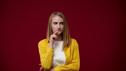 Blonde thinks and suddenly one idea comes to mind Stock Footage 163880879