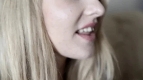 Blonde throws grape in her mouth and sucks merrily close-up Stock Footage 100854279