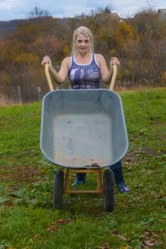 Blonde with a wheelbarrow Stock Photos