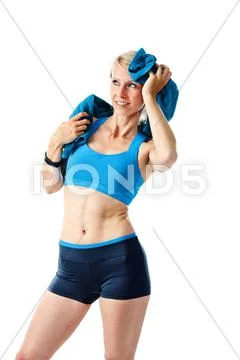 Blonde woman after fitness workout drying herself with a towel Stock Photos