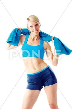 Blonde woman in blue sports wear holding a towel around her shoulder looking Stock Photos