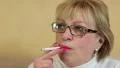 Blonde woman with a cigarette on yellow background HD Footage