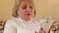 Blonde woman with closed eyes sits on the sofa and listens to music HD Footage