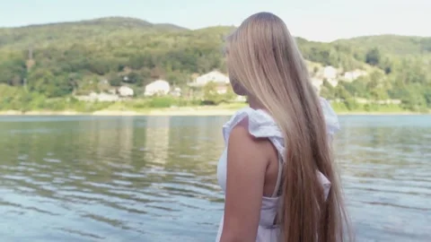 Blonde woman with long hair at the lake Stock Footage