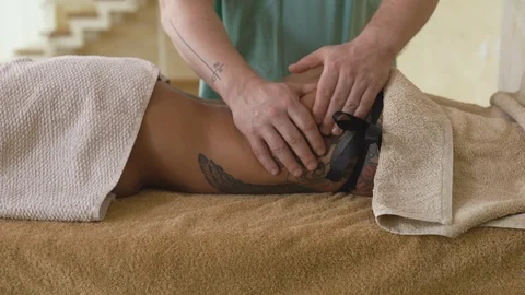 Blonde woman relaxing receiving back massage from male