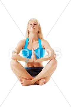 Blonde woman sitting with legs crossed meditating Stock Photos