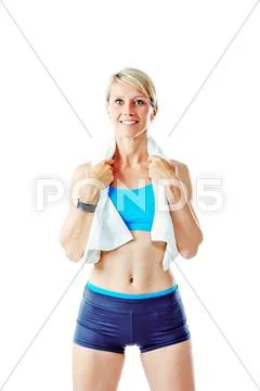 Blonde woman smiling to the camera wearing sports wear and holding white towe Stock Photos