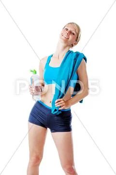 Blonde woman in sports wear satisfied with her performance holding a water bo Stock Photos