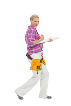 Blonde woman standing while playing with a spirit level Stock Photos