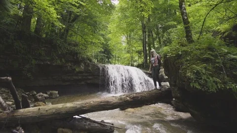 Blonde woman travel in nature mountain with backpack Stock Footage