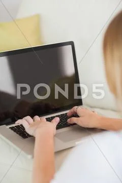 Blonde woman typing on laptop Stock Photos