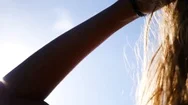 Blonde Woman With Windswept Hair Against Sunlight Stock Footage