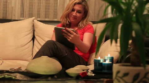 Blonde women using digital tablet Stock Footage 37874725