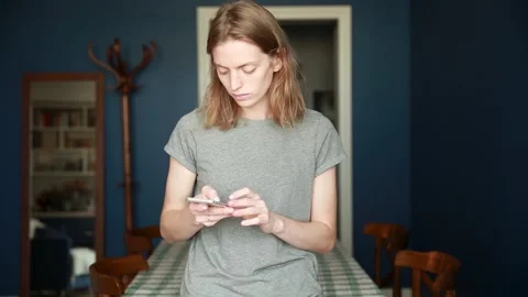 The blonde writes a message on her mobile phone Stock Footage 138981933