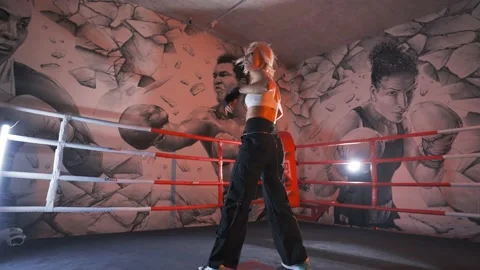 Blonde young female dancer energetically dancing modern dances in the ring 4K Stock Footage 212010941