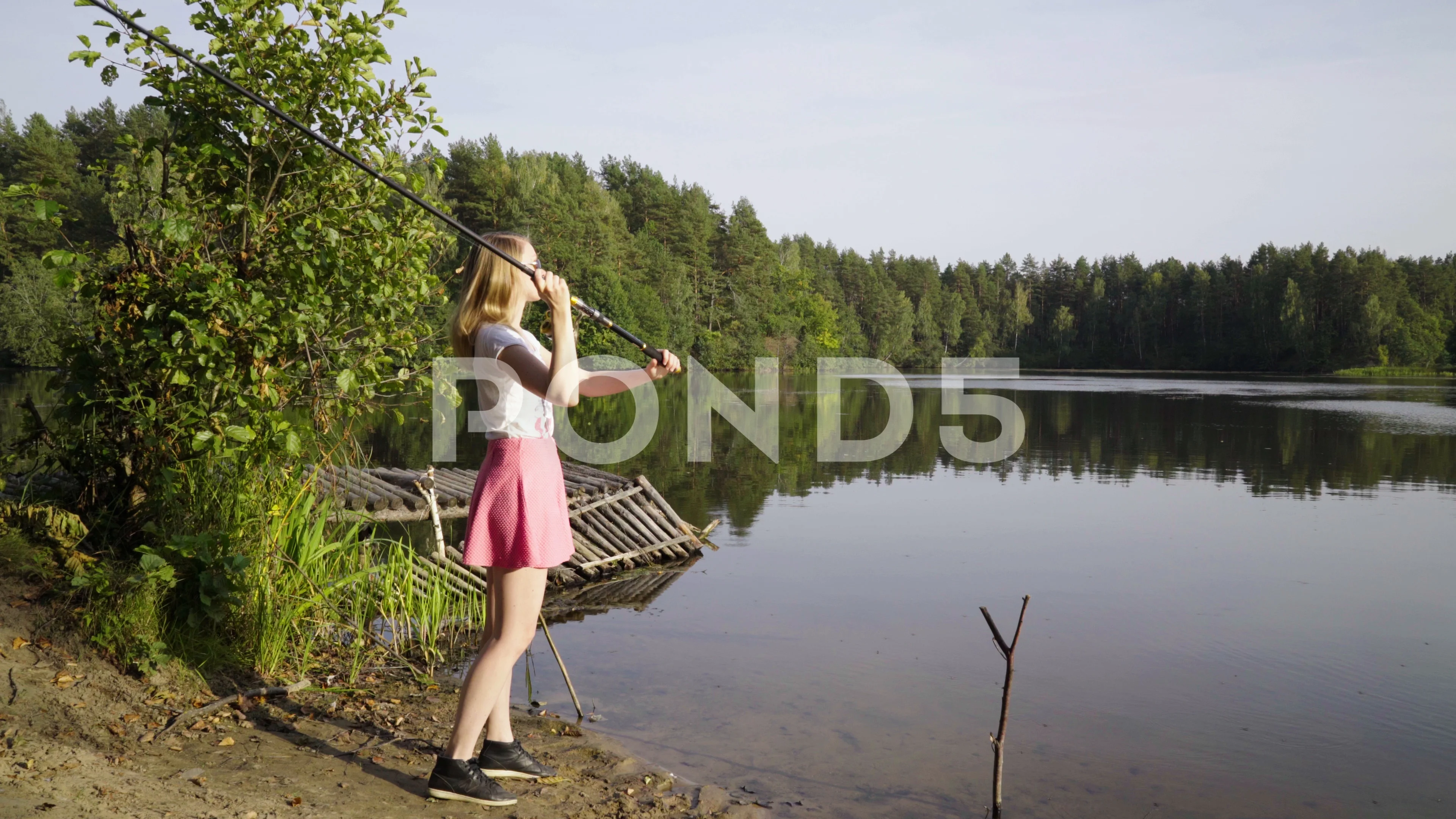 Blonde young girl fisherman is fishing o, Stock Video