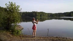 Blonde Young American Girl Fisherman is Fishing on the Forest Lake