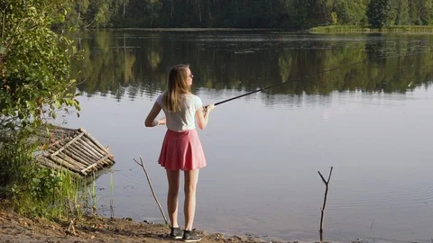 Premium Photo  Young adult woman is fishing alone on fast