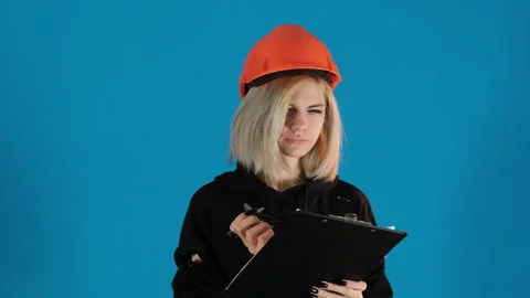 Blonde young lady makes notes on paper talking to interlocutor Stock Footage 306502028