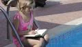 Blone child girl reading a book HD Footage