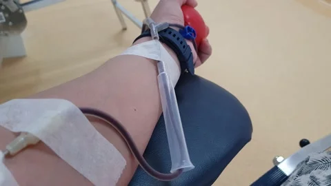 Blood donation, left hand pumping  the red color ball for faster blood flow Stock Footage 201851294