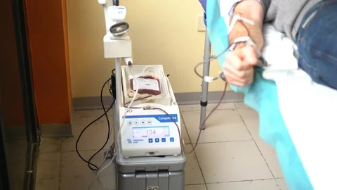 Blood donor at donation Stock Footage 99875601