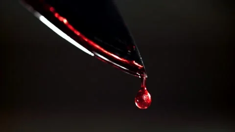 Blood Dripping from a Sharp Metal Knife Blade Close Up Macro Shot 库存影片 331101628