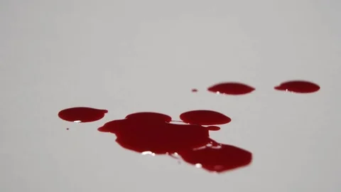 Blood dripping on a white surface. Stock Footage 82900493