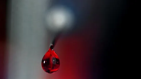 Blood Drop Falling from a Sharp Metal Needle in a Laboratory Setting 库存影片 331101548