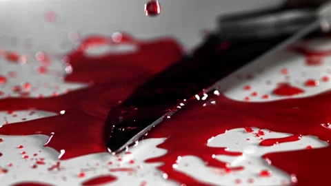 Blood Drops Falling Onto a Sharp Metal Kitchen Knife on White Surface 库存影片 331101577