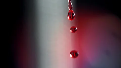 Blood Drops Falling in Slow Motion Against a Dark Abstract Background 库存影片 331101790