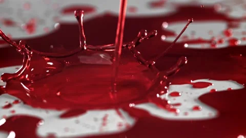 Blood Drops Splashing into a Deep Red Liquid Pool on a Smooth White Surface Vídeos de archivo 331101570