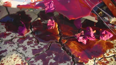 Blood flows down on dry scorched earth from the broken body of electric guitar Video stock 293886140