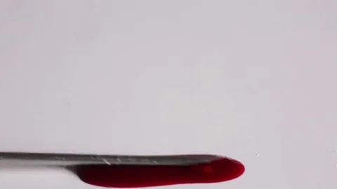 Blood flows from syringe on a white background Stock Footage 69178374
