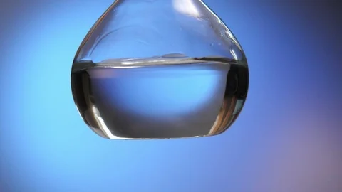 Blood is injected in a big round flask with a coronavirus testing liquid in lab Stock-Footage 127216178