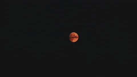 A blood moon in 2020 wandering over the ... | Stock Video | Pond5