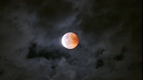 Blood moon eclipse with clouds covering the moon, 27. July 2018 Stock Footage 98005342