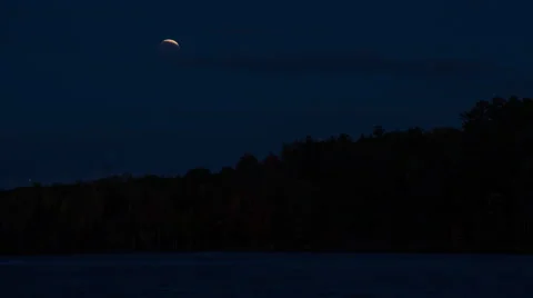 Blood moon setting as sun rises Stock Footage 43874268