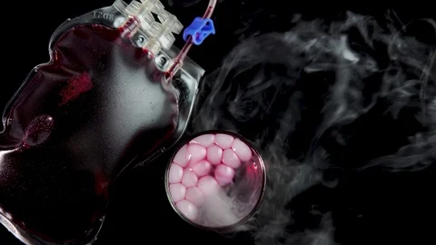 Blood pack with red bubbles drink on black background. Halloween concept. Video stock 118900881