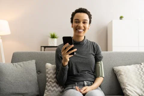 Blood Pressure Check Using Smart Monitor Stock Photos