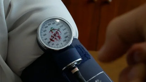 Blood pressure measurement of patient in clinic Stock Footage