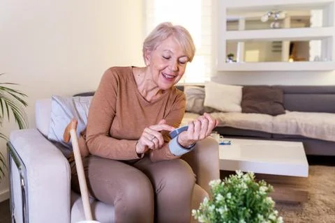 Blood pressure testing at home. Checking Blood pressure Level At Home. Senior Stock Photos
