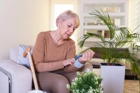 Blood pressure testing at home. Checking Blood pressure Level At Home. Senior Stock Photos